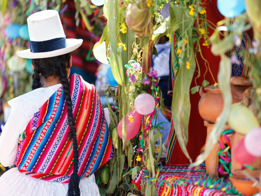 A traditional Peruvian woman walks in a Peruvian market.