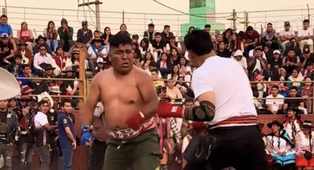 Two men are fighting during the Peruvian fighting festival.