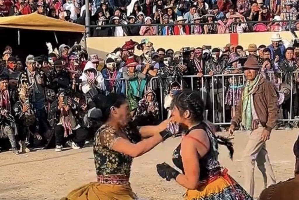 Two women fight furing the fighting festival in Peru.