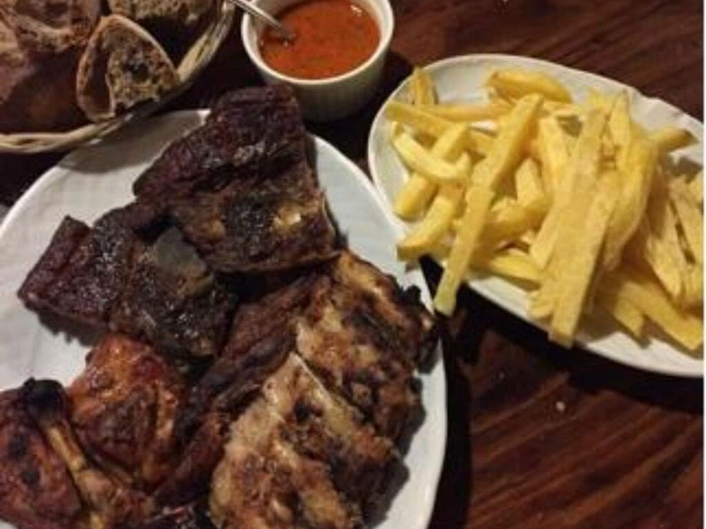 Churrasco with bread fries and bbq sauce in Spain.