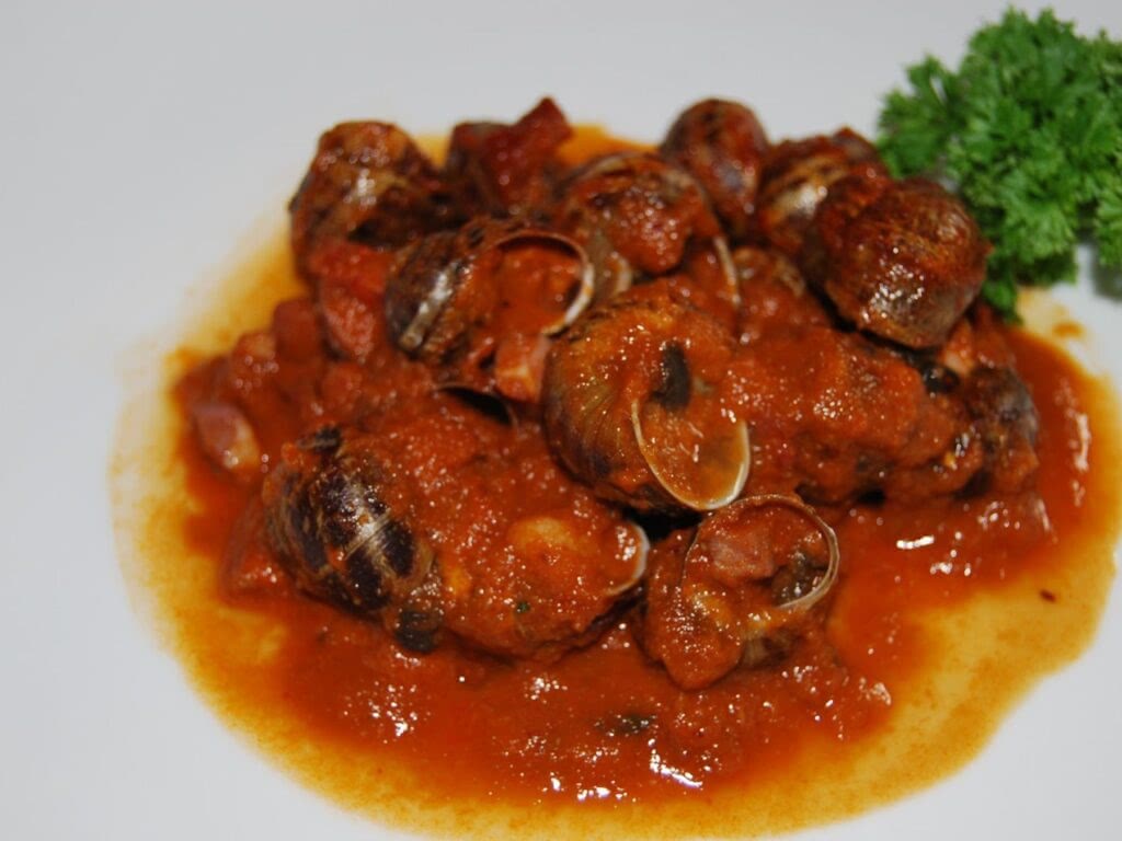 Snails cooked in a tomato sauce.