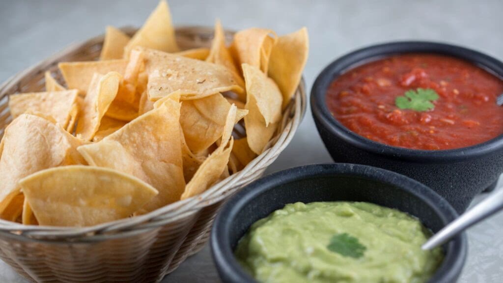 Mexican chips and salsa with guacamole. 
